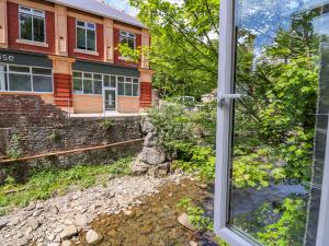 a view of a building from a window at River Cottage in Port Talbot