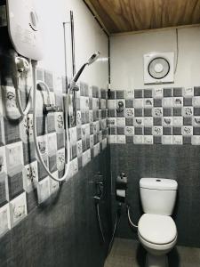 a bathroom with a shower and a toilet in it at Miyonra - Anuradhapura in Anuradhapura