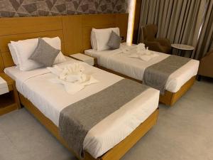 MothiMahal Residency Thrissur客房内的一张或多张床位