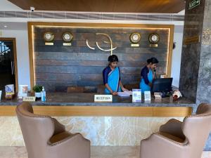 two women standing at a counter in a restaurant at MothiMahal Residency Thrissur in Trichūr