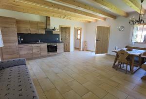 a large kitchen with a table and a dining room at Strass4 in Neumarkt-Sankt Veit +6 photos