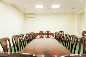 a conference room with a long table and chairs at Russiya in Voronezh