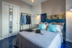 a bedroom with a bed with a laptop on it at B&B il Duca d'Amalfi in Salerno