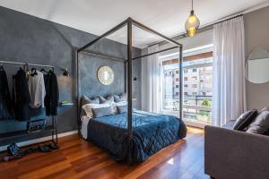 a bedroom with a canopy bed and a window at B&B il Duca d'Amalfi in Salerno