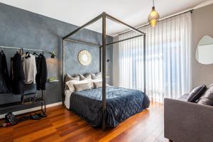 a bedroom with a canopy bed in a room at B&B il Duca d'Amalfi in Salerno