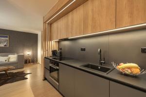 a kitchen with a sink and a counter top at Savoy Exclusive Mountain Apartment in Špindlerův Mlýn