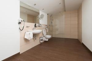a bathroom with a toilet and a sink at Apart Krismer in Ladis +16 photos
