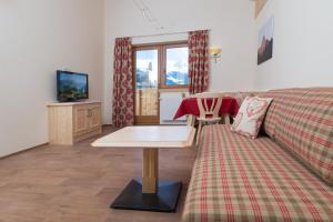 a living room with a couch and a table at Apart Krismer in Ladis