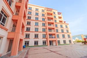 a large orange building with a lot of windows at Mabaat - Beach Tower - Building B - 251 in King Abdullah Economic City