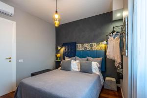 a bedroom with a blue bed with a blue headboard at B&B il Duca d'Amalfi in Salerno