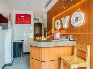 a restaurant with a counter with aoops sign on the wall at OYO 431 Apollo 11 Apartelle in Manila