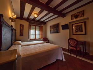 a bedroom with a large bed and a window at Posada de San Millán in Sepúlveda