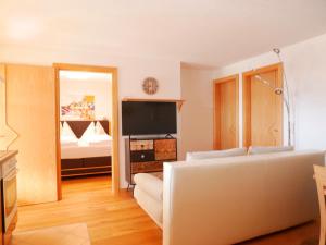 a living room with a couch and a bed at Appartements Tauernzauber in Schladming