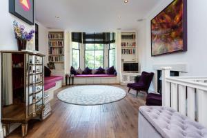 ロンドンにあるVeeve - La Vie En Roseの紫色の家具と大きな窓が備わるリビングルームが付いています。
