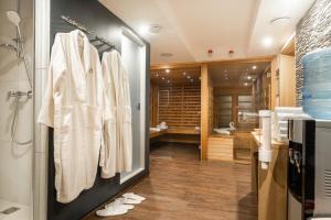a bathroom with white towels hanging on a wall at Onyx Luxury Sarvar in Sárvár +94 photos