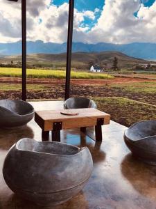 a table and chairs in front of a view of a field at Cellar1980 in Robertson
