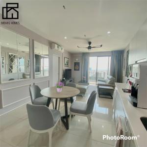 a living room with a table and chairs at Hyde Tower I-city by Mohas Homes in Shah Alam