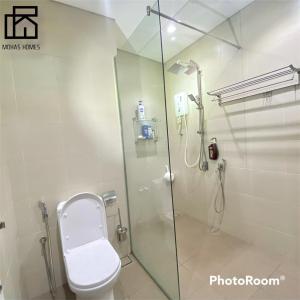 a bathroom with a shower with a toilet and a glass door at Hyde Tower I-city by Mohas Homes in Shah Alam