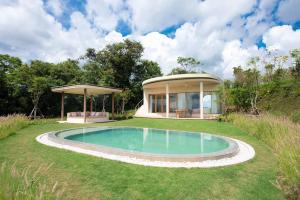 a house with a pool in the middle of a yard at Sala Khaoyai in Wangkata