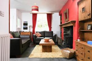 a living room with two couches and a table at Stone Cottage at Staveley in Windermere
