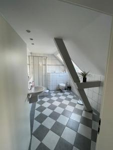 a bathroom with a sink and a toilet and a staircase at Kanal-Haus "Das Gästehaus direkt am NOK" in Osterrönfeld +100 photos