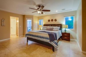 a bedroom with a bed and a ceiling fan at Devon Getaway in San Diego