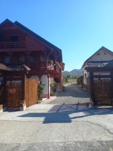 a group of buildings with gates and a street at Pension Ioana Lavita in Vadu Izei