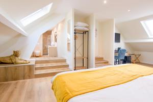 a bedroom with a large bed and a staircase at Castello in Pierrefonds