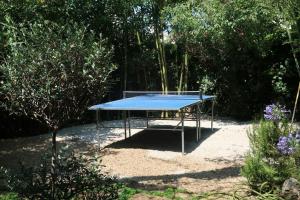 a blue ping pong table sitting in the sand at Cap d'Antibes 50m from the beach 3 bedrooms/Pool in Antibes