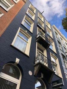a blue building with windows and a balcony at Hotel D'Amsterdam Leidsesquare in Amsterdam