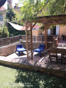 a patio with blue chairs and a hammock at Appartement avec Jardin privatif centre ville in Hyères