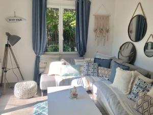 a living room with a couch and a table at Cap d'Antibes 50m from the beach 3 bedrooms/Pool in Antibes
