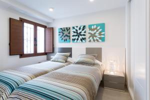 2 camas en una habitación en Rincón del Duende, en Sevilla
