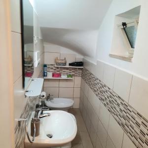 a bathroom with a sink and a toilet at Appartamento Limone in Cala Gonone +33 photos