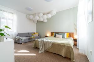 a bedroom with a bed and a couch at Penzion Expo Dream #33 by goodnite cz in Brno
