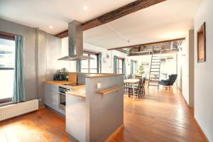a kitchen and dining room with a table and chairs at The Old Town Lodge in the Heart of Antwerp in Antwerp