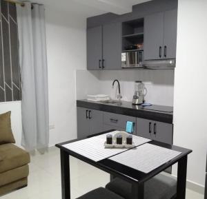 a small kitchen with a table in a room at UMBRELLA SUITE in Manta