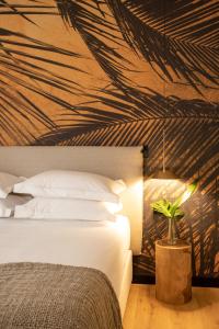 a bedroom with a bed and a palm leaf ceiling at Ciutat de Girona in Girona