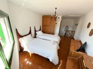 a bedroom with two beds and a window at Central House at Tejeda's Heart with Amazing View in Tejeda