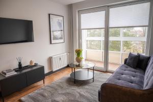 a living room with a couch and a table at Trumpalaikė nuoma Telšiuose in Telšiai