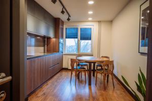 a kitchen with a table and chairs in a room at Trumpalaikė nuoma Telšiuose in Telšiai