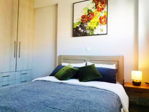 a bedroom with a bed and a painting on the wall at 7-Athens new morden comfortable-center,metro,private parking in Athens