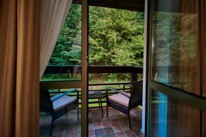 a view of a balcony with chairs and a table at Hotel & Restaurant Sofia in Suceviţa