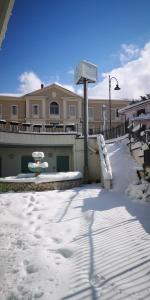 a building with a playground in the snow at Hotel San Berardo in Pescina
