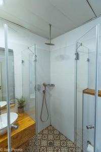 a bathroom with a shower and a sink at Dizengoff 208 Hotel Tel Aviv in Tel Aviv