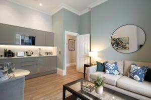 a living room with a couch and a table at Redmayne House - Urban Apartments in Bristol