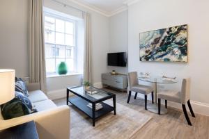 a living room with a couch and a table at Redmayne House - Urban Apartments in Bristol