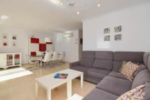 a living room with a couch and a table at Jardines del Pla in Jávea