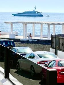 a group of cars parked next to the water with a boat at Luxury Suite Sea Front IV in Playa Honda