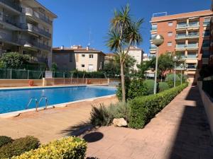 a swimming pool in the middle of a building at PLATANERA apart in Calafell